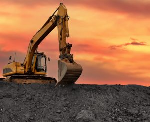 Coal mining. Excavator on earthmoving at open pit mining. Backhoe dig ore in quarry on sunset. Heavy construction equipment and Heavy Machinery during excavation. Excavator on iron ore mining.