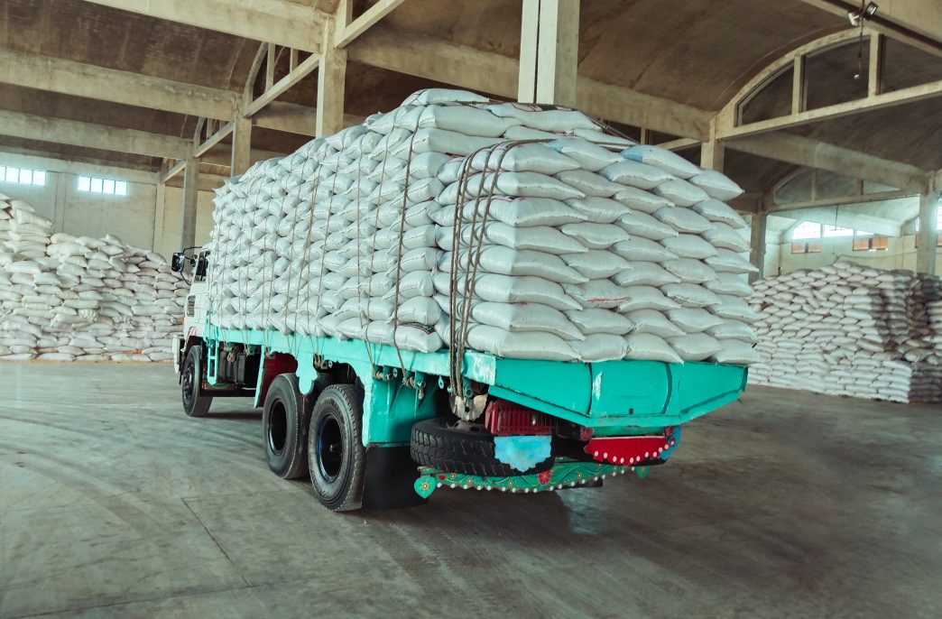 Truck laden with bags white sacks in a warehouse godown factory stocks supply  camion charge de sacs image photo.