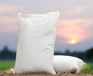 Fertilizer bag over sunrise and rice field background